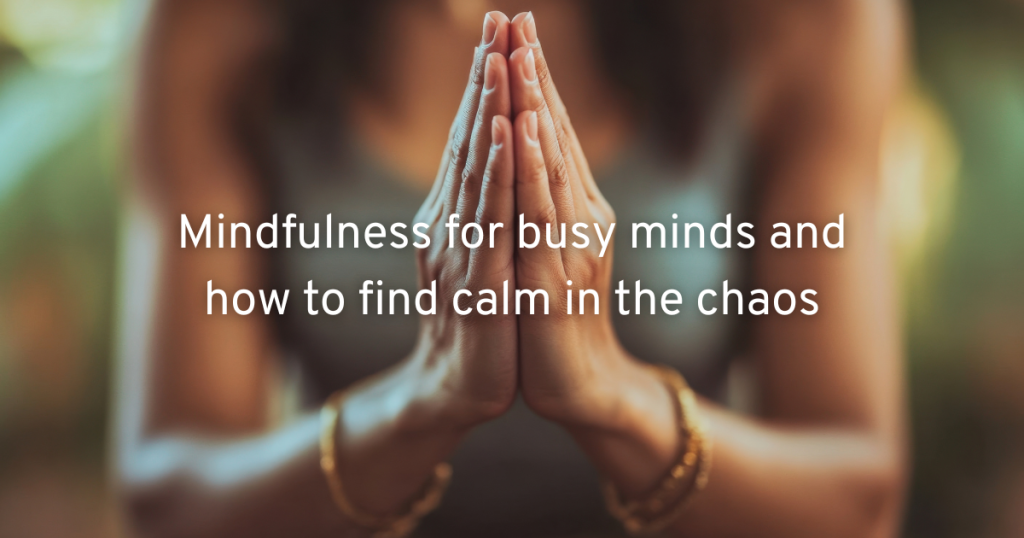 a woman practising mindfulness for a busy mind by sitting, closing her palms together and breathing deeply