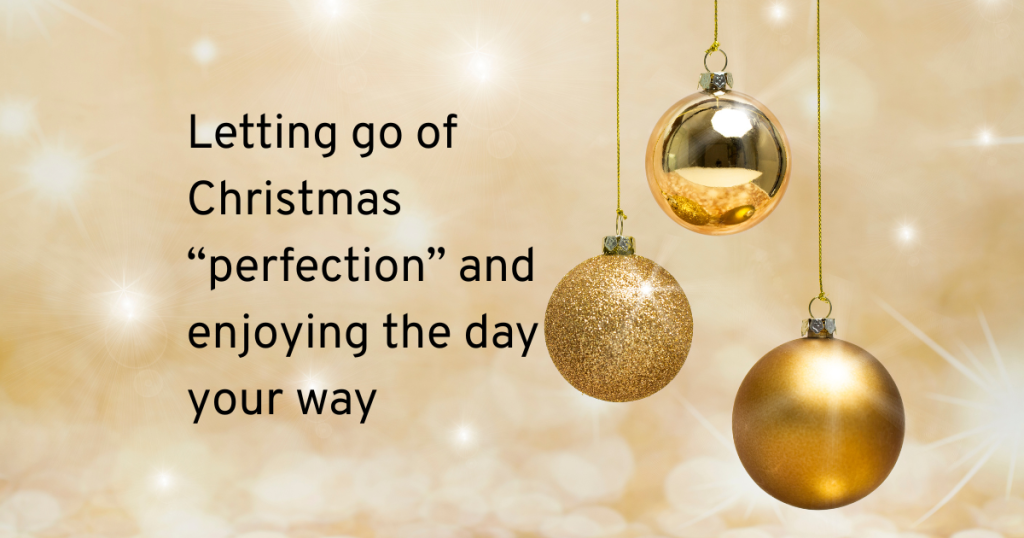 Gold baubles hanging down a gold background with text that reads letting go of Christmas perfection and enjoying the day your way