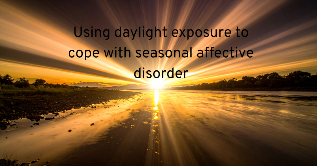 A BRIGHT SUN SHINING OIVER A WETLAND AND TEXT SAYING USING DAYLIGHT EXPOSURE TO COPE WITH SEASONAL AFFECTIVE DISORDER