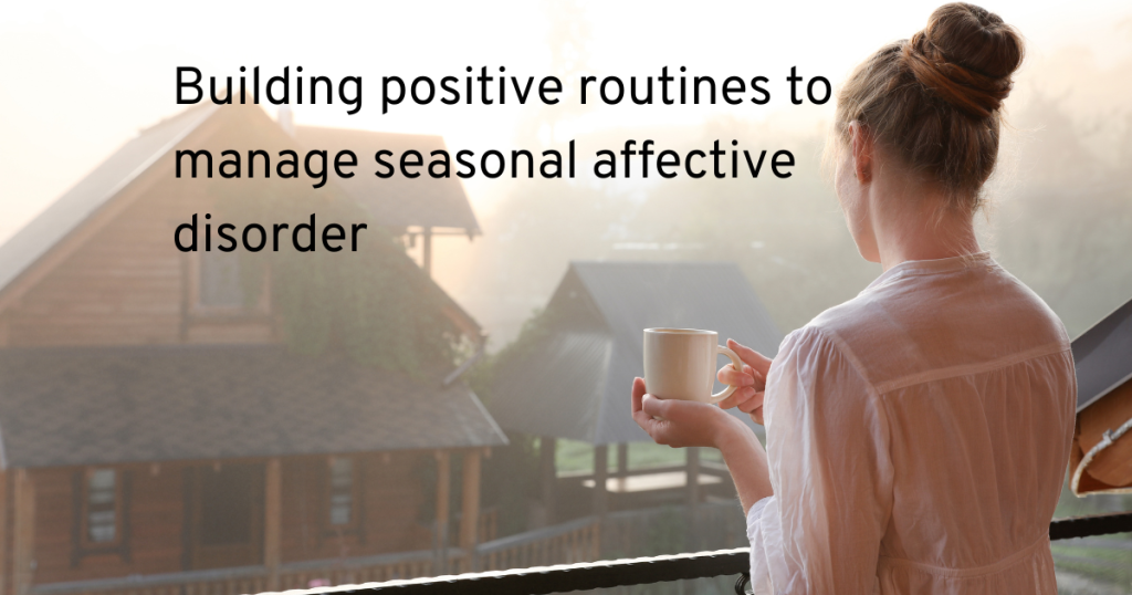 woman standing on a balcony in winter with a morning coffee building a positive routine to manage seasonal affective disorder