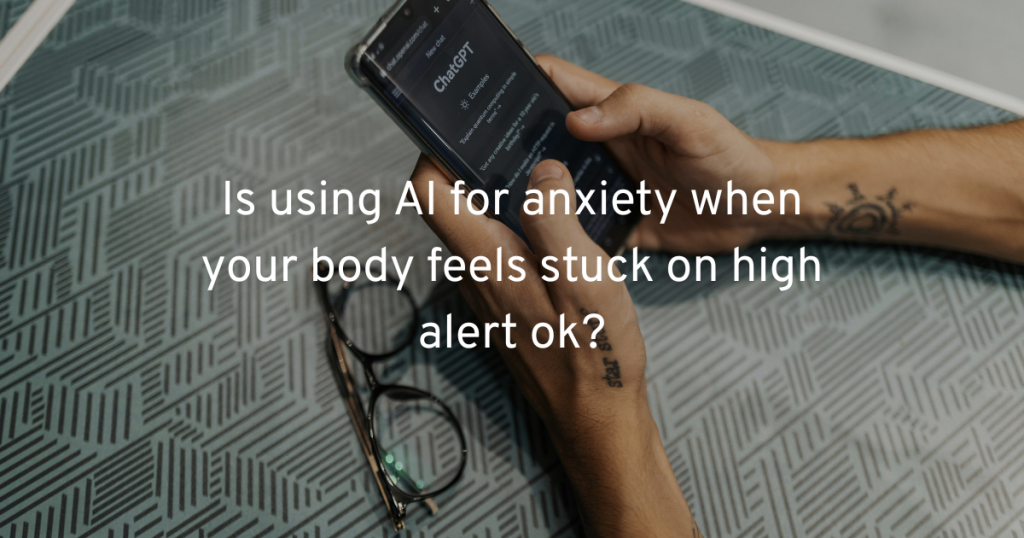 an image showing hands with subtle tattoos on teh wrists holding a phone woth chatgpt app open about to type. resting in a patterned gray table with glasses closed to the side. text reading us using ai for anxiety when your body feels stuck on high alert ok?
