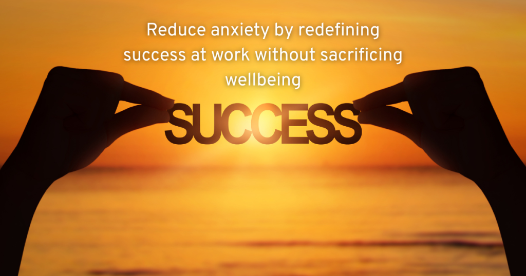 TWO HANDS HOLDING UP THE WORD SUCCESS TO A SUNSET SHOWING US THAT WE CAN REDUCE ANXIETY BY REDEFINING WHAT SUCCESS AT WORK LOOKS LIKE WITHOUT SACRIFICING OUR WELLBEING