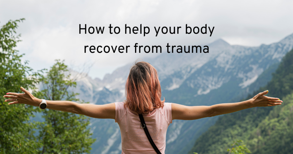 woman stood in the mountains with her back to the camera, maybe practising breathwork and learning how to heal your body recover from trauma
