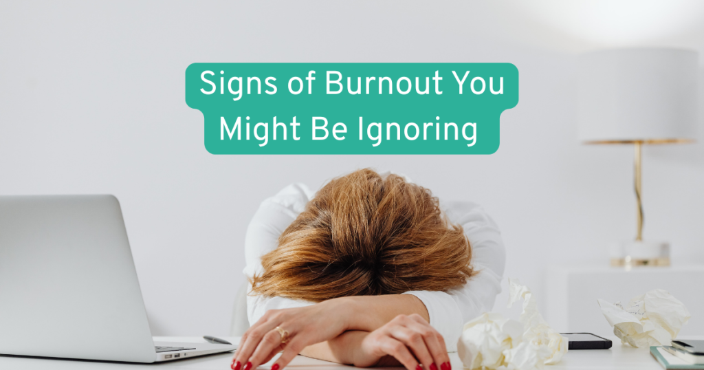 a woman with her head on her desk showing signs of burnout