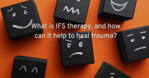 an orange background showing black tiles with different faces on them in chalk showing your differeing internal family systems. with text- what is IFS therapy and how can it help to heal trauma
