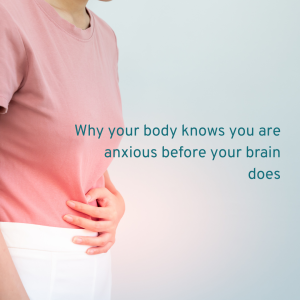 PERSON WEARING A PINK T SHRT AND WHITE TROUSERS HOLDING THEIR STOMACH AS THEY LEARN Why your body knows you are anxious before your brain does