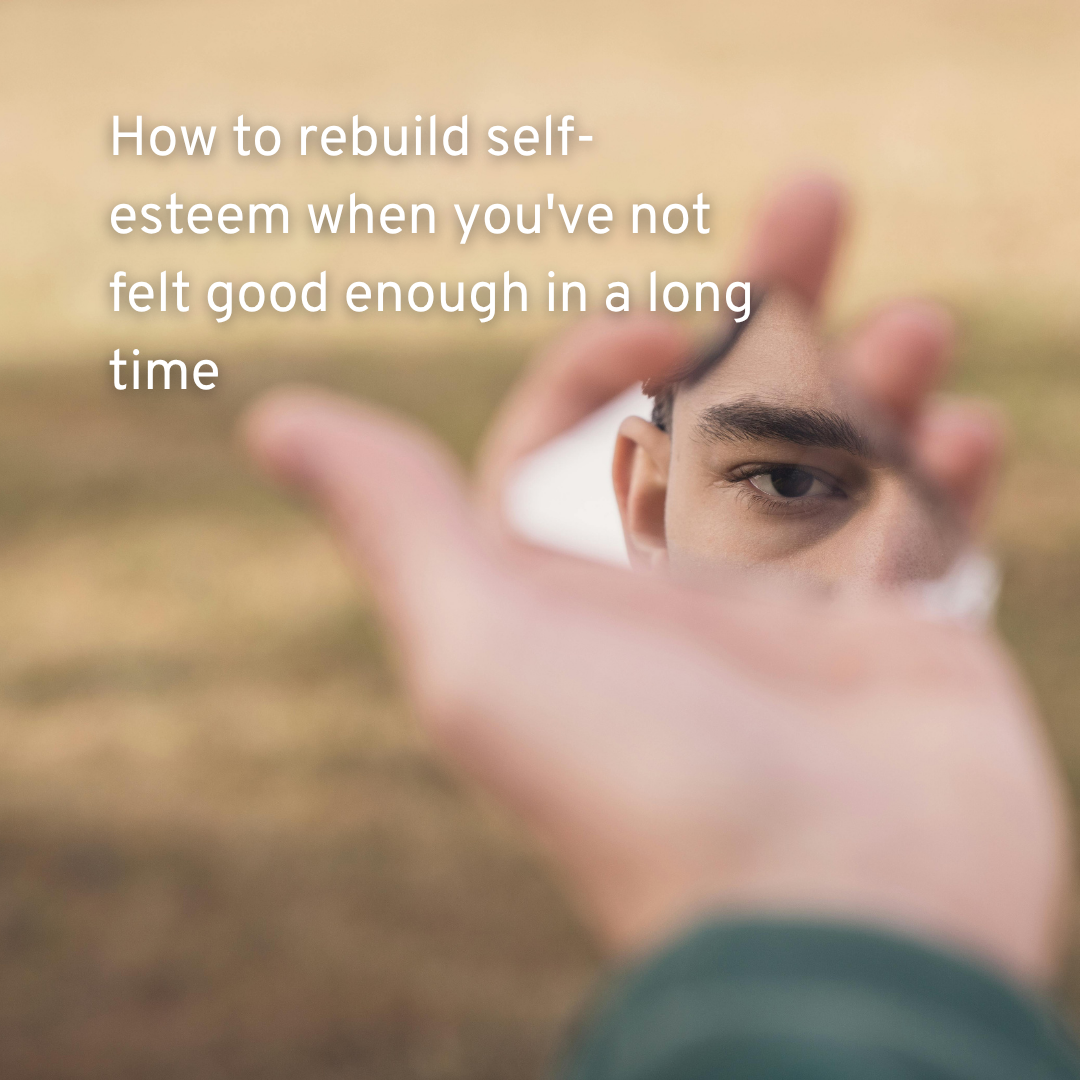 a hand holding a shard of mirror with a man looking deeply into it and text how to rebuild self-esteem